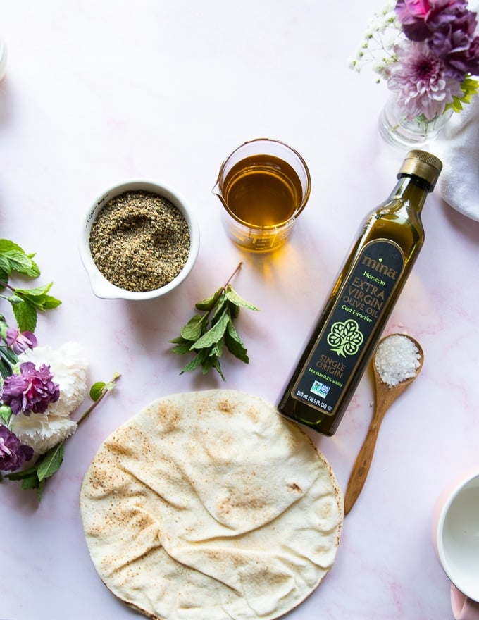 A bottle of Moroccan olive oil, zaatar spice and zaatar spice