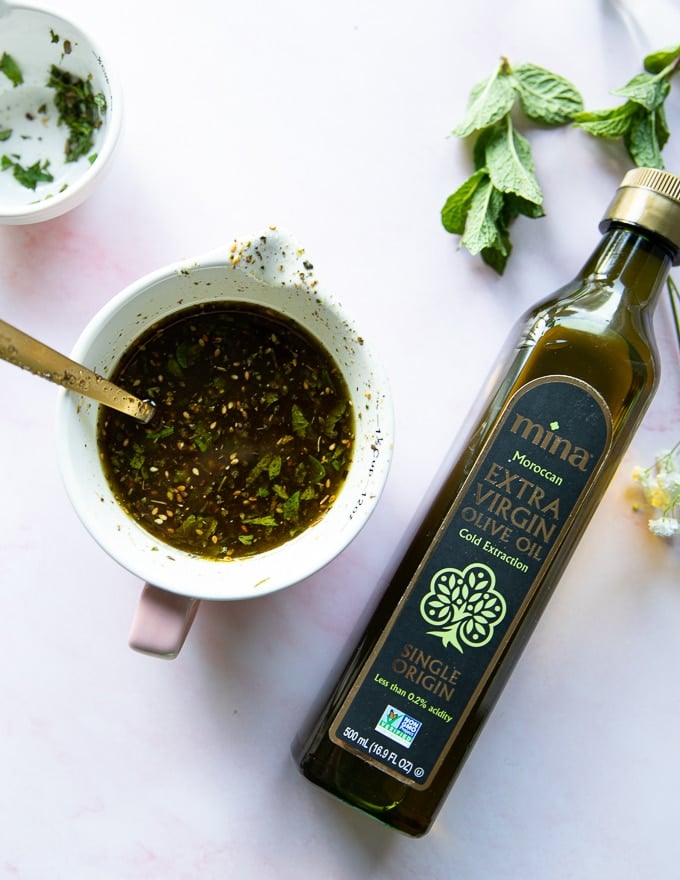 bottle of moroccan olive oil near a bowl of zaatar