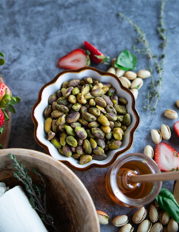 Pistachios in a bowl and honey