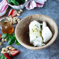 A bowl of goat cheese with honey and thyme