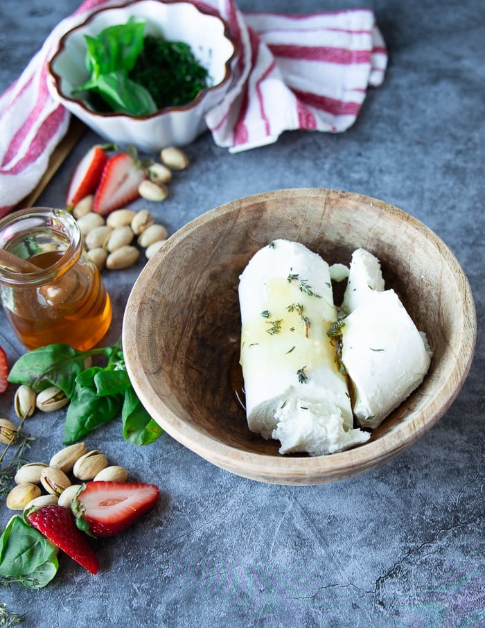 A bowl of goat cheese with honey and thyme