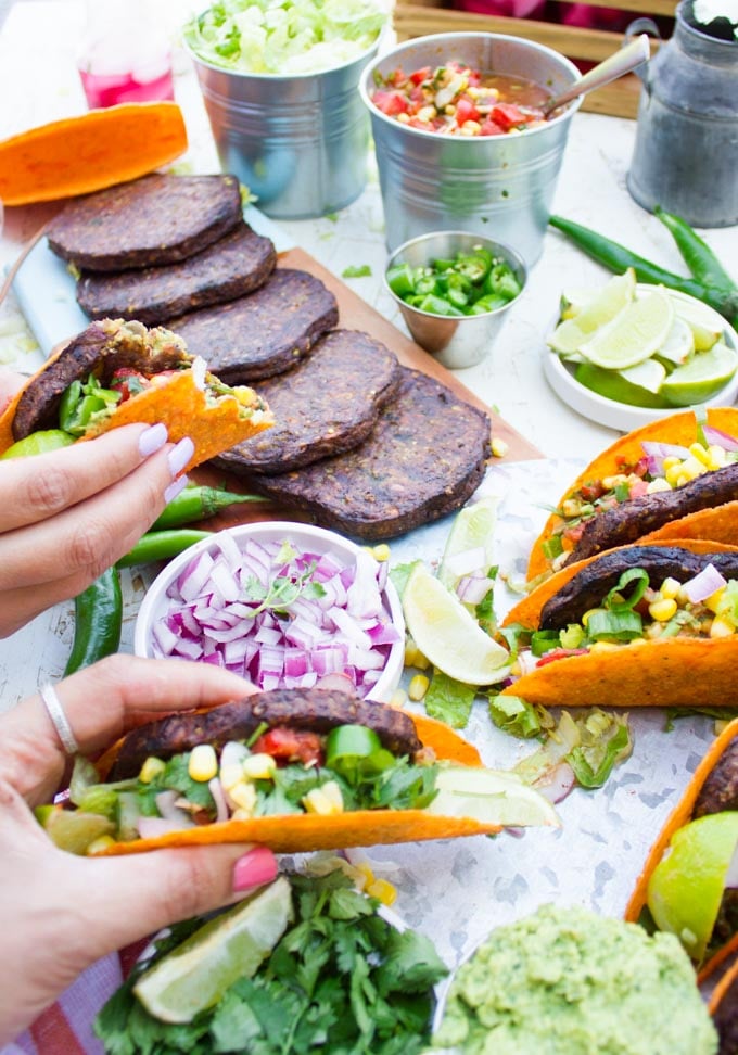 two hands holding burger tacos showing them at different angles