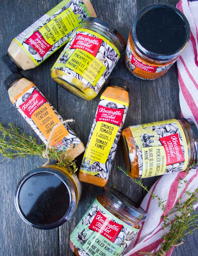 A variety of Kensington Market Foods Salad dressings and pickled in glass jars