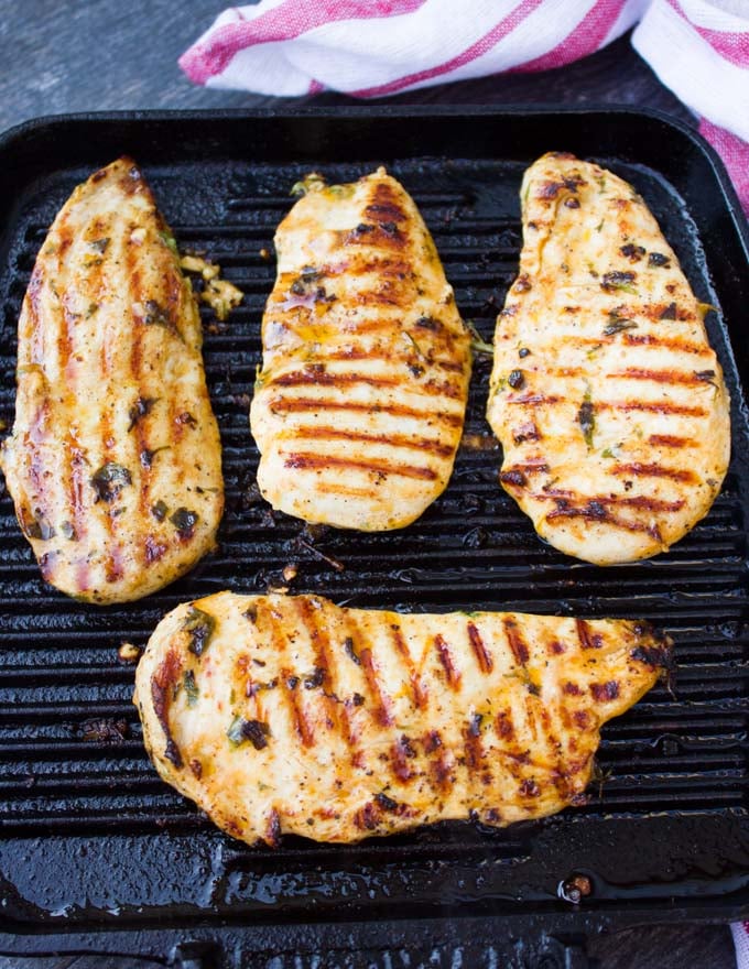 grilled chicken breasts on a grill skillet ready to eat