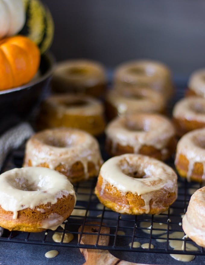 glazed pumpkin donuts over a cooling rack