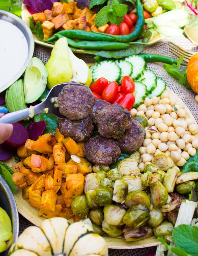 Adding the lamb meatballs to the nourish bowl