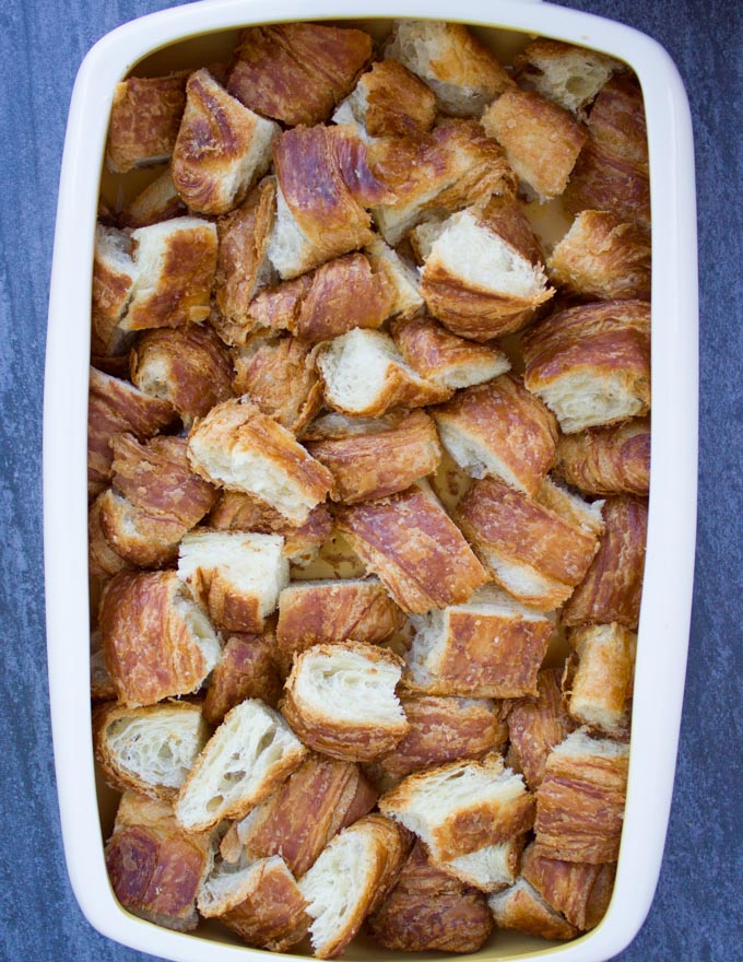 an oven safe dish filled with croissants cubes