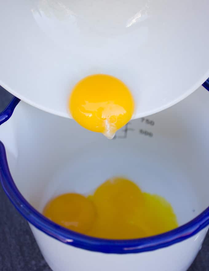 egg yolks poured into a small pot