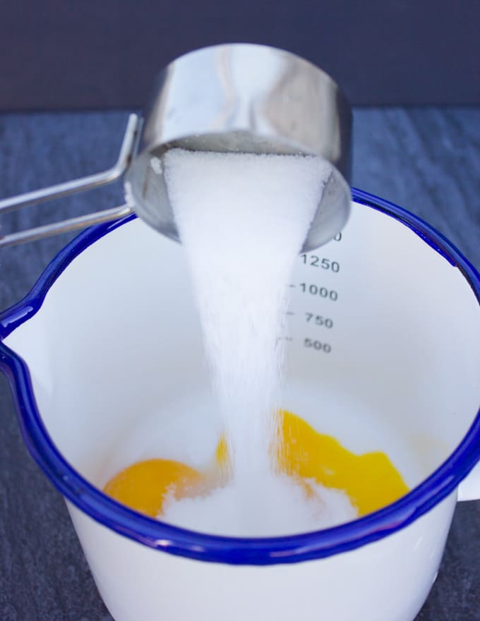 sugar poured over the egg yolks in a small pot