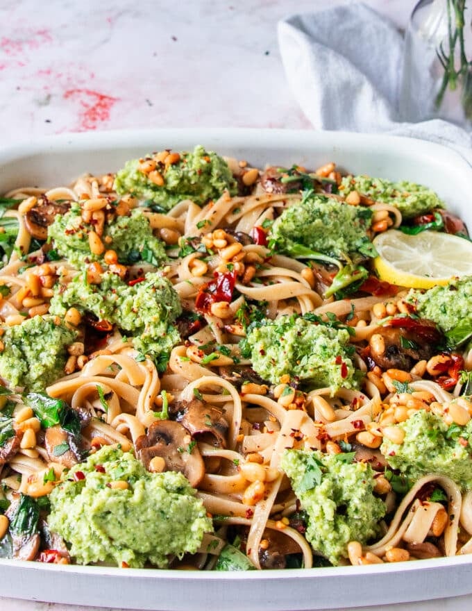 close up of a broccoli pesto pasta plate showing the dollops of broccoli pesto close up immersed into the pasta