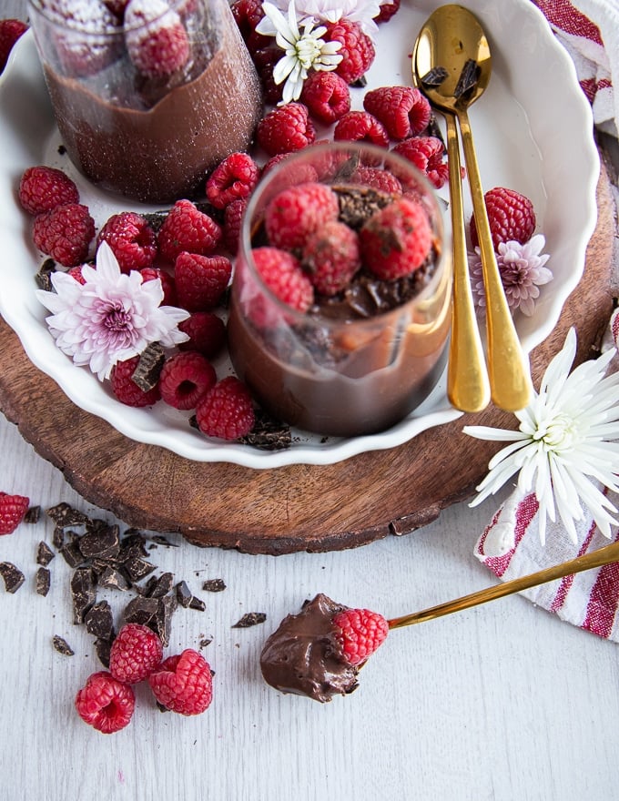 A spoon with some chocolate pudding scooped and placed ont he surface showing the texture