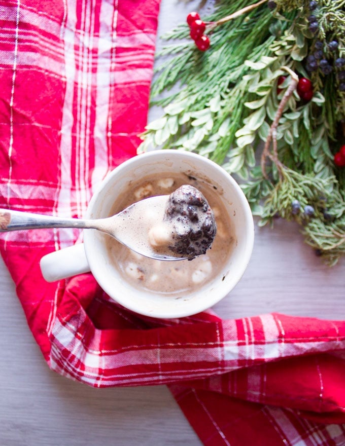 A spoonful of melted OREO cookie balls over a cup of hot chooclate