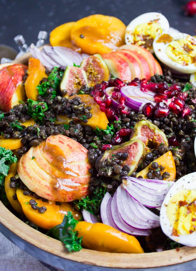 A close up view showing details of the massaged kale and some spicy lentils over the salad