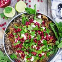 A top view of a plate of lentils and rice cooked mujadara recipe with crispy fried onions and herbs