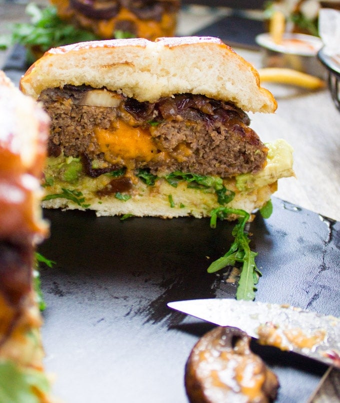 A cheese stuffed burger cut in half showing the cheese stuffing.