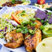 close up of the cooked fish for the fish taco recipe and lemon slices