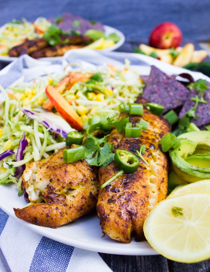 close up of the cooked fish for the fish taco recipe and lemon slices