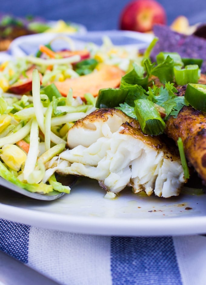 A piece of fish tacos recipe cut up showing succulent fish inside