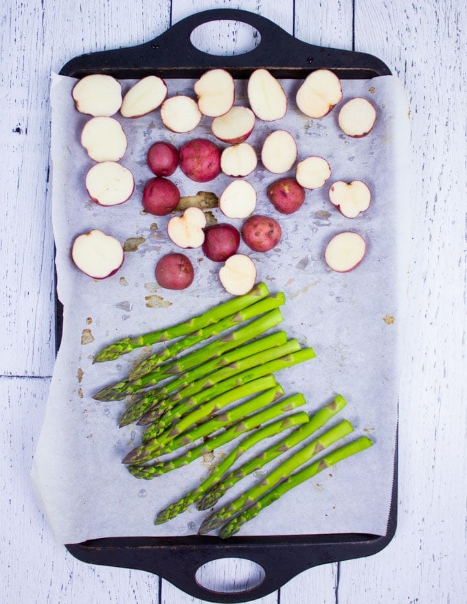 A pan with asparagus and potatoes ready for the grill