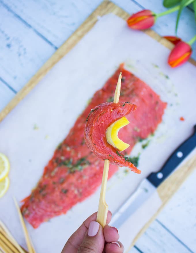 Fillet of salmon ready to be cut up and skewered with lemon