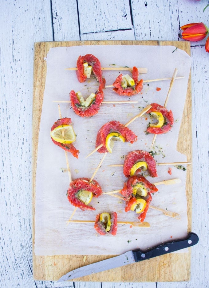 a set of salmon skewered with lemon slices and ready to grill for the salmon salad