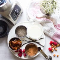 Ingredients for chia seed pudding: chia seeds, dates, milk, vanilla and cocoa powder and a blender