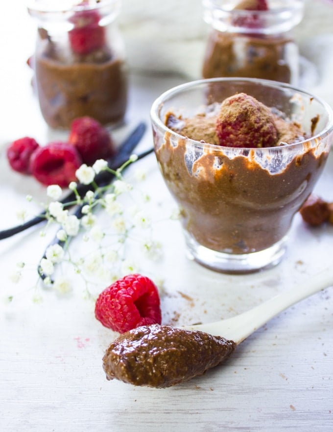 A spoon with chocolate chia seed pudding scooped and put on a board to show the texture of the pudding 