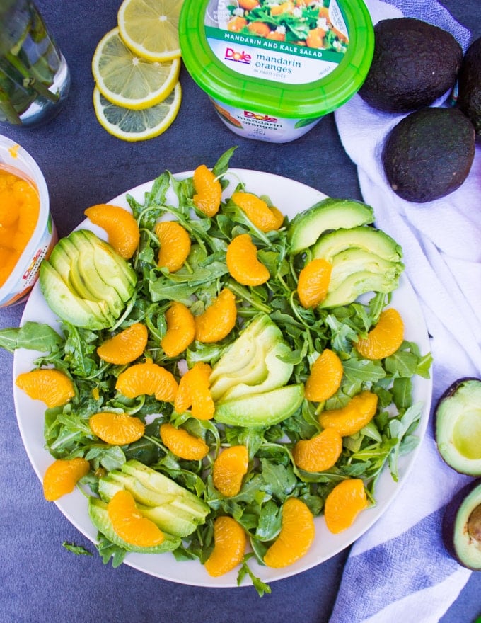 Avocado salad with greens, mandarin oranges, avocados and ready for the dressing.