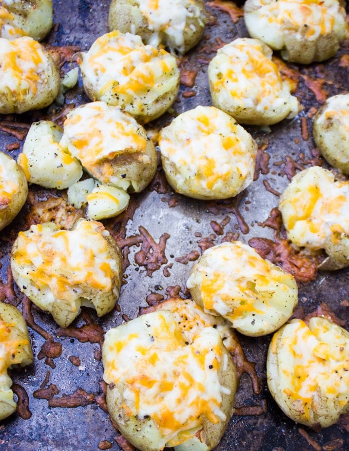 smashed potatoes out of the oven sprinkled with cheese melted