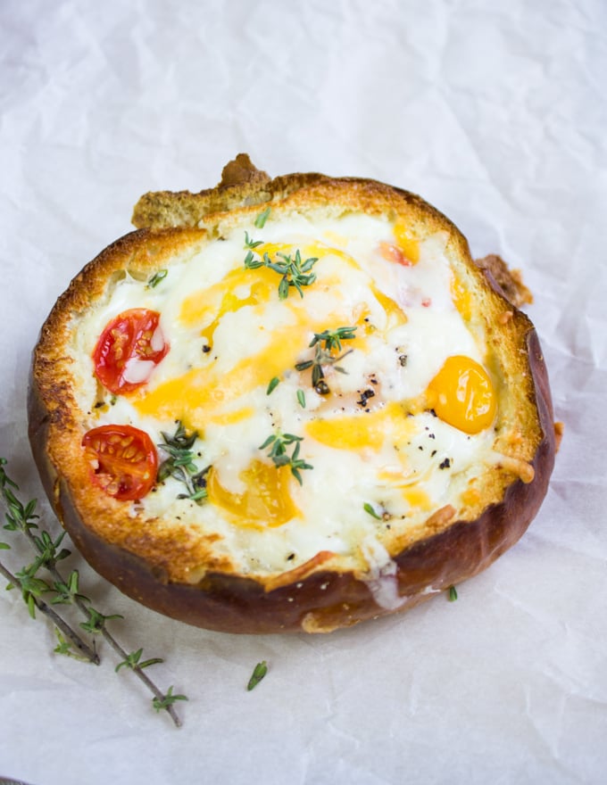 Close up of the baked eggs in bread bowl with extra cheese