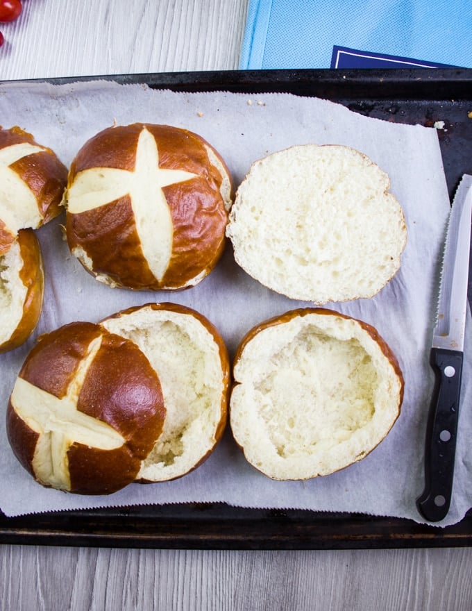 Pretzel bread buns split in half and emptied in the center