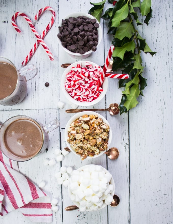 Hot chocolate bar toppings: a bowl of marshmallows, crushed nuts, candy canes, chocolate chips