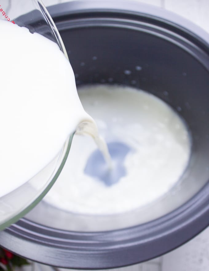 pouring the milk into crockpot