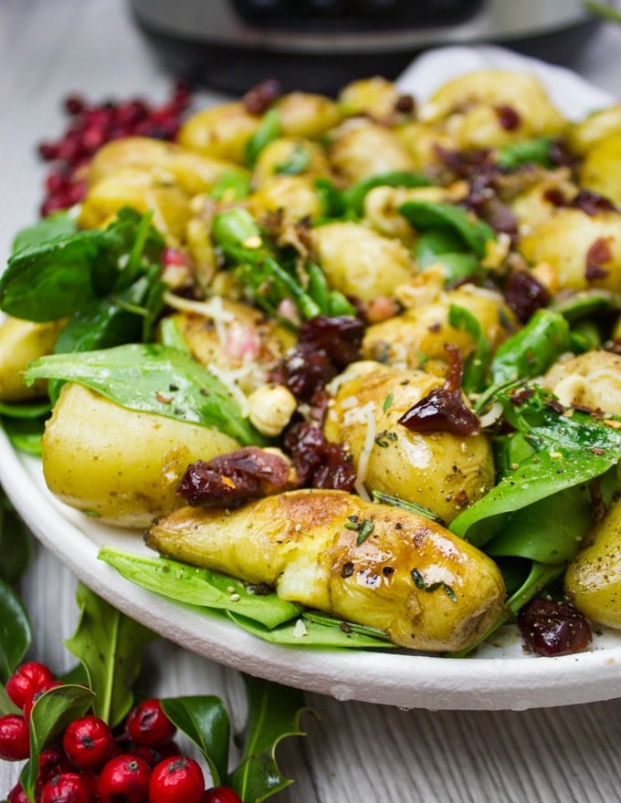 A close up of the potato salad with golden crust and spinach