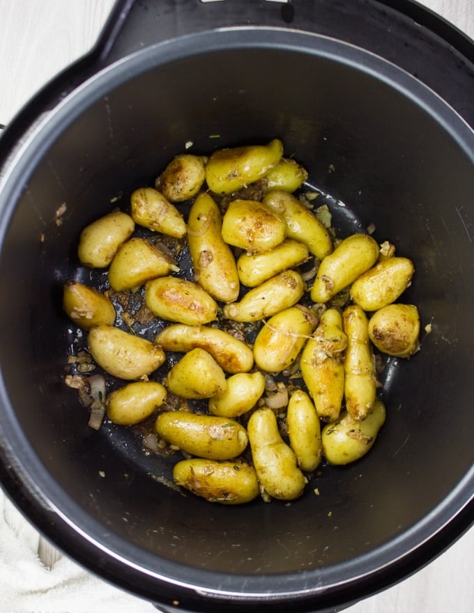 Potatoes getting golden with butter on the sear function in the Crock-Pot