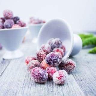 A bowl pouring sugared cranberries showing