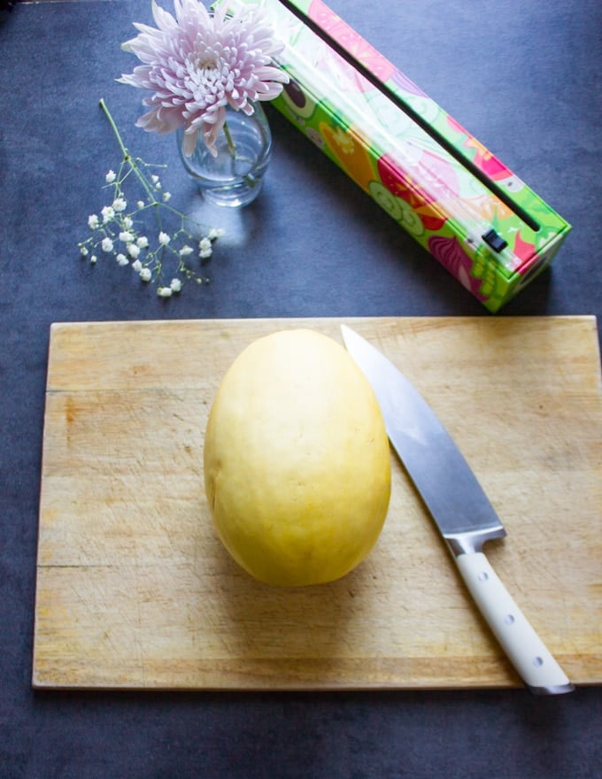 A spaghetti squash whole on a cutting board