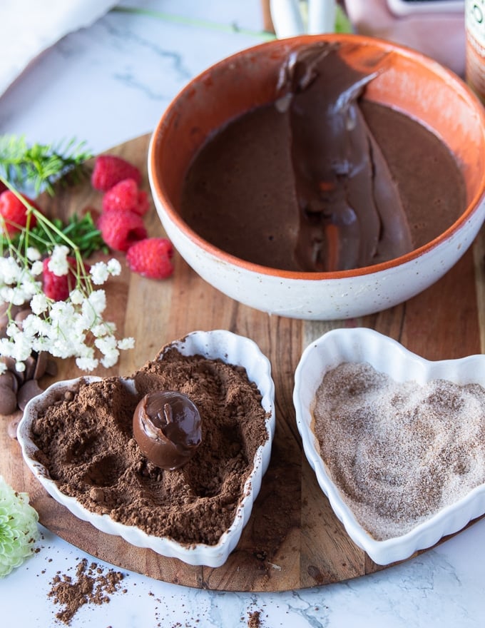 a chocolate truffles mixture added to the cocoa powder bowl to coat