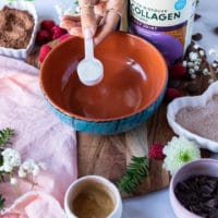 flavored collagen being added to the bottom of a bowl