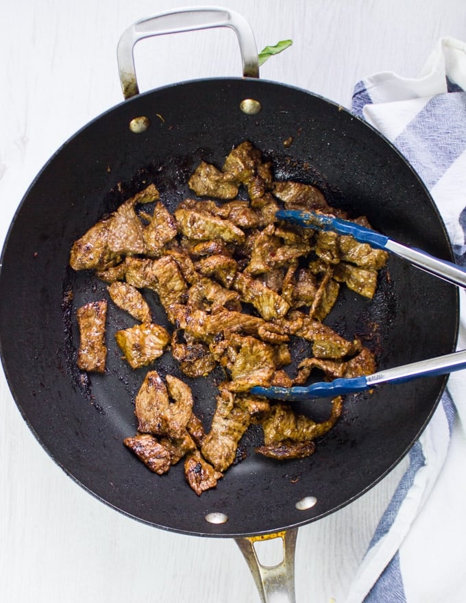 The lamb cooked and ready in the wok