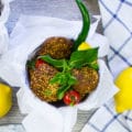 three falafels in a bucket with fresh mint