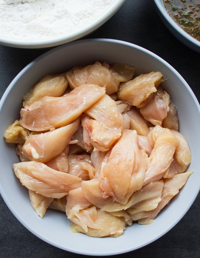 Raw chicken strips in a bowl