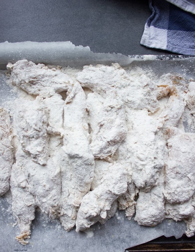 Chicken coated in flour and ready for frying