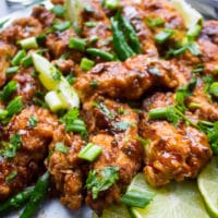 Korean Fried Chicken Strips with lime slices and cilnatro