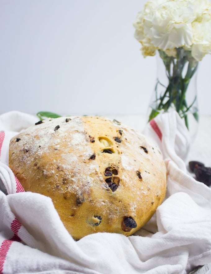 A whole load of bread out of the oven on a kitchen towel 