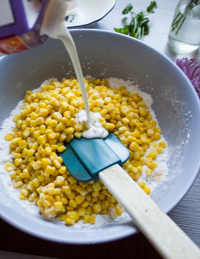 Corn and milk added to the bowl to make the batter