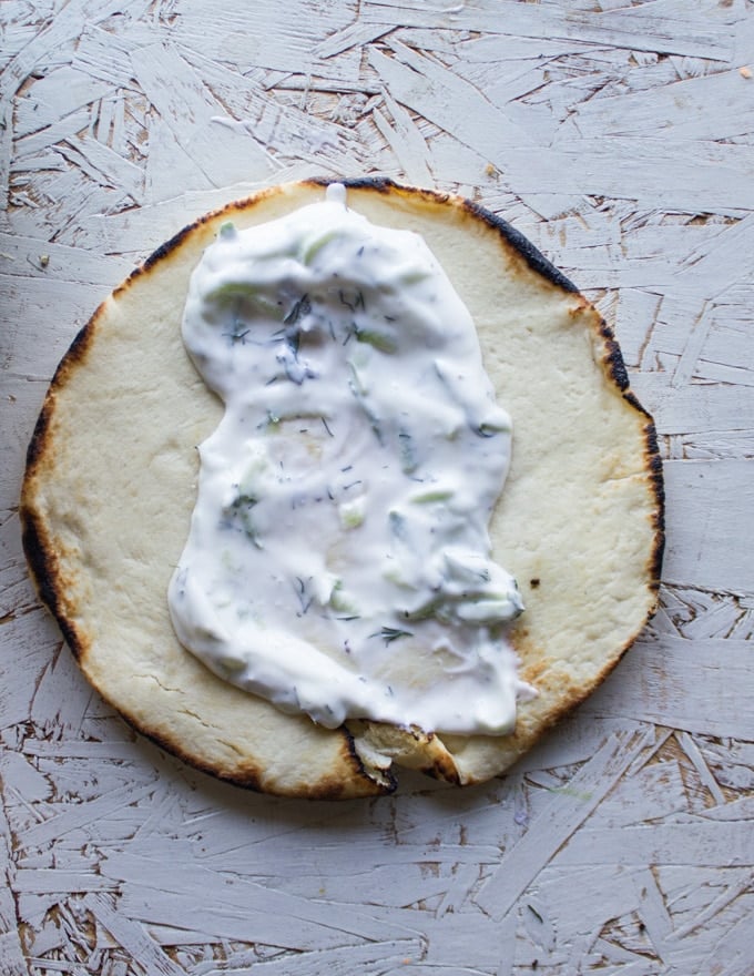 Pita bread spread with Tzatziki Sauce