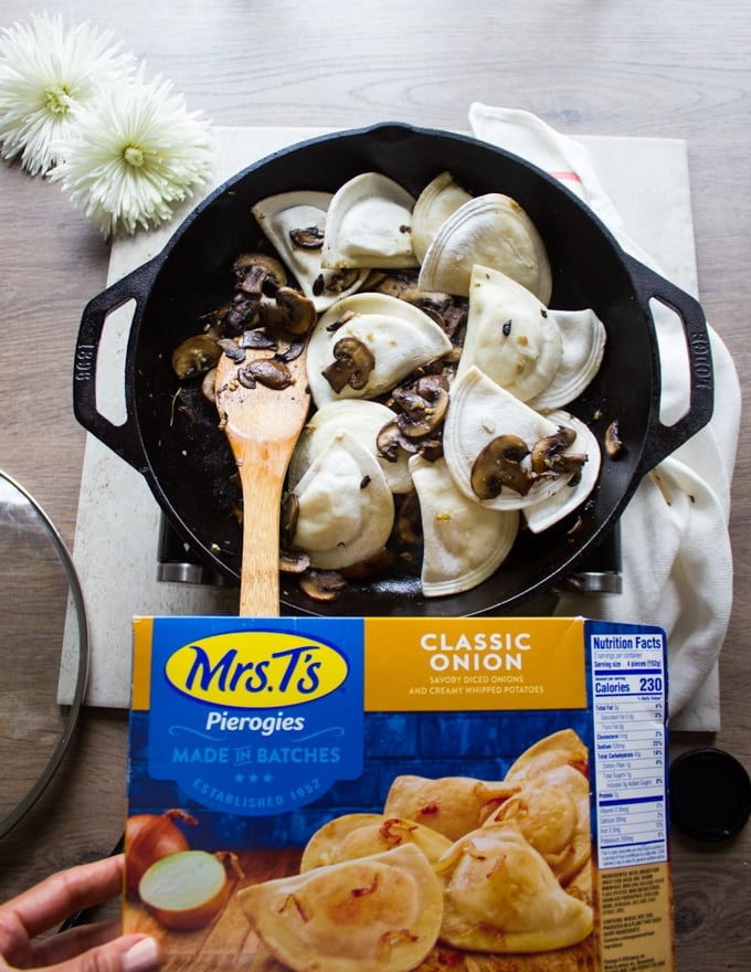 A box of Mrs.T's Pierogies frozen being added to the mushroom pan