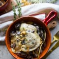 One bowl of Alfredo Recipe with pierogies, mushrooms, crispy onions and a fork