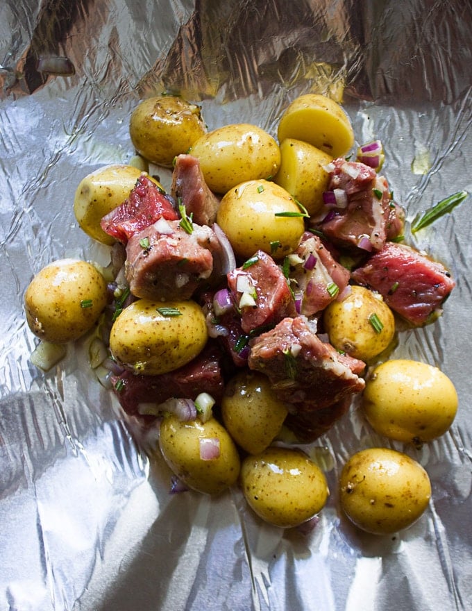 The lamb and potatoes mixture divided among 4 foil packets